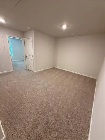 an empty room with mirror and entrance