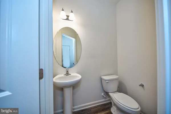 a bathroom with a toilet a sink and a mirror