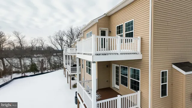 a view of a house with a wooden fence