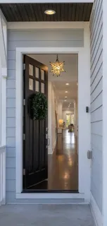 a view of a livingroom with furniture wooden floor and a chandelier