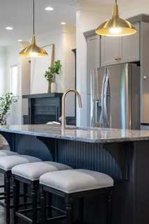 a kitchen with granite countertop a sink stainless steel appliances and cabinets