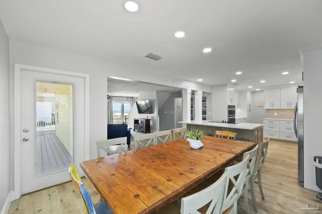 a large kitchen with stainless steel appliances kitchen island a large counter top a stove and a refrigerator