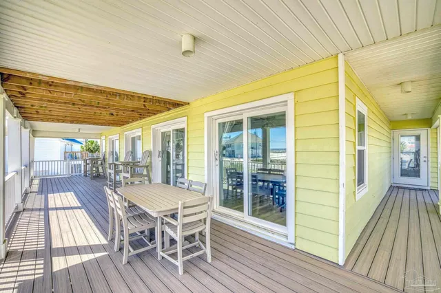 a view of a patio with table and chairs and wooden floor