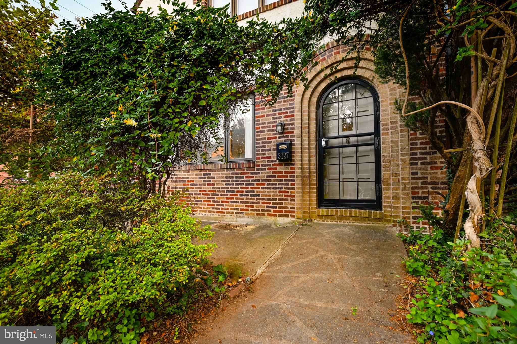 3727 Rexmere Road Baltimore, MD 21218 - Photo 3 of 56 Stucco & stone facade with arched brick doorway...