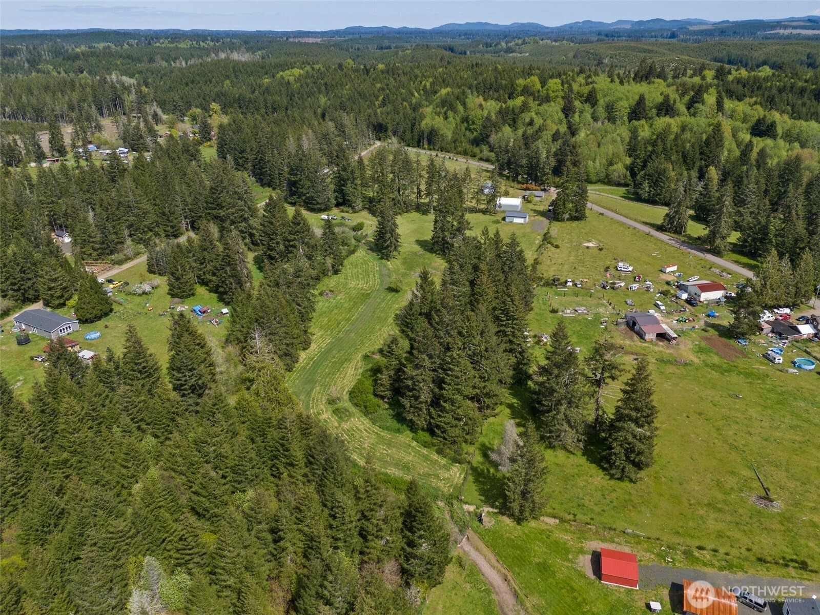 1982 West Ford Loop Road Elma, WA 98541 - Photo 8 of 15 a view of a lush green hillside and houses