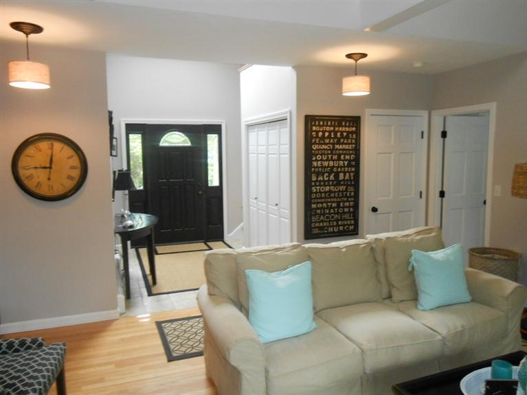 9 Bunker Circle Sandwich, MA 02563 - Photo 11 of 19 a living room with furniture a large window and a chandelier