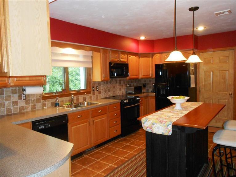 9 Bunker Circle Sandwich, MA 02563 - Photo 8 of 19 a kitchen with stainless steel appliances kitchen island granite countertop a sink a stove and a refrigerator