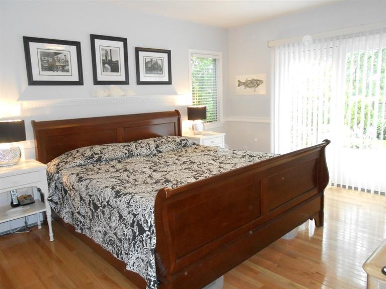 9 Bunker Circle Sandwich, MA 02563 - Photo 10 of 19 a bedroom with a bed and wooden floor