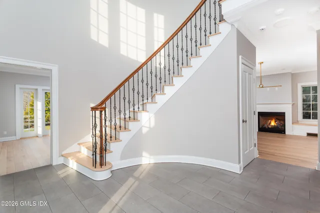 a living room with furniture a large window and a chandelier