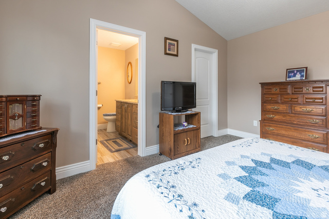 1228 North Providence Way Tooele, UT 84074 - Photo 15 of 28 Carpeted room featuring a vaulted ceiling and neutral wall tones