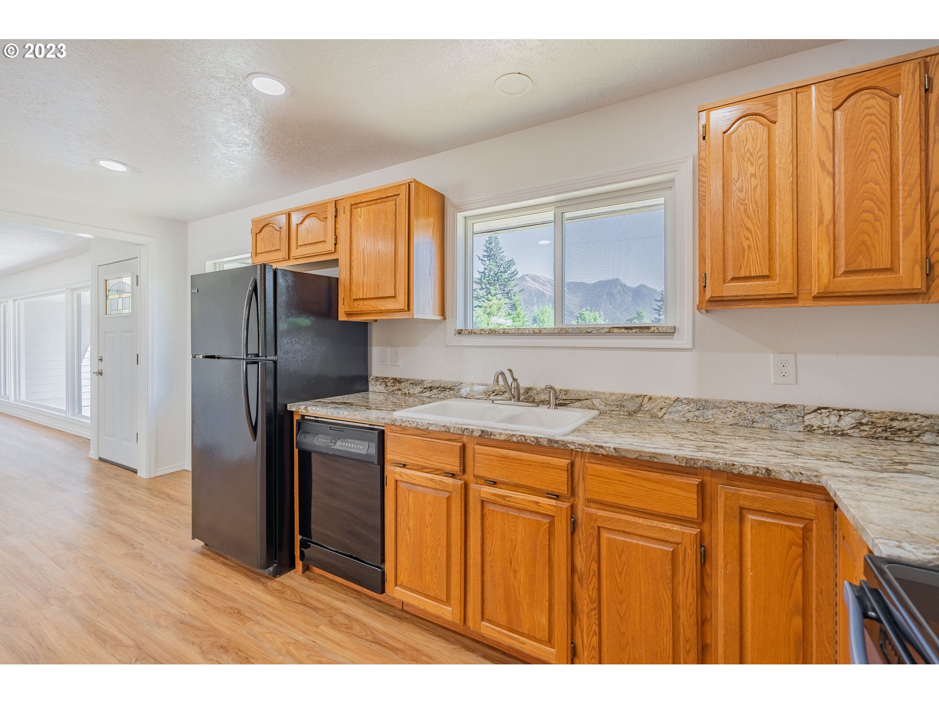 721 Northwest Gropper Road Stevenson, WA 98648 - Photo 16 of 45 a kitchen with stainless steel appliances granite countertop a refrigerator and a sink