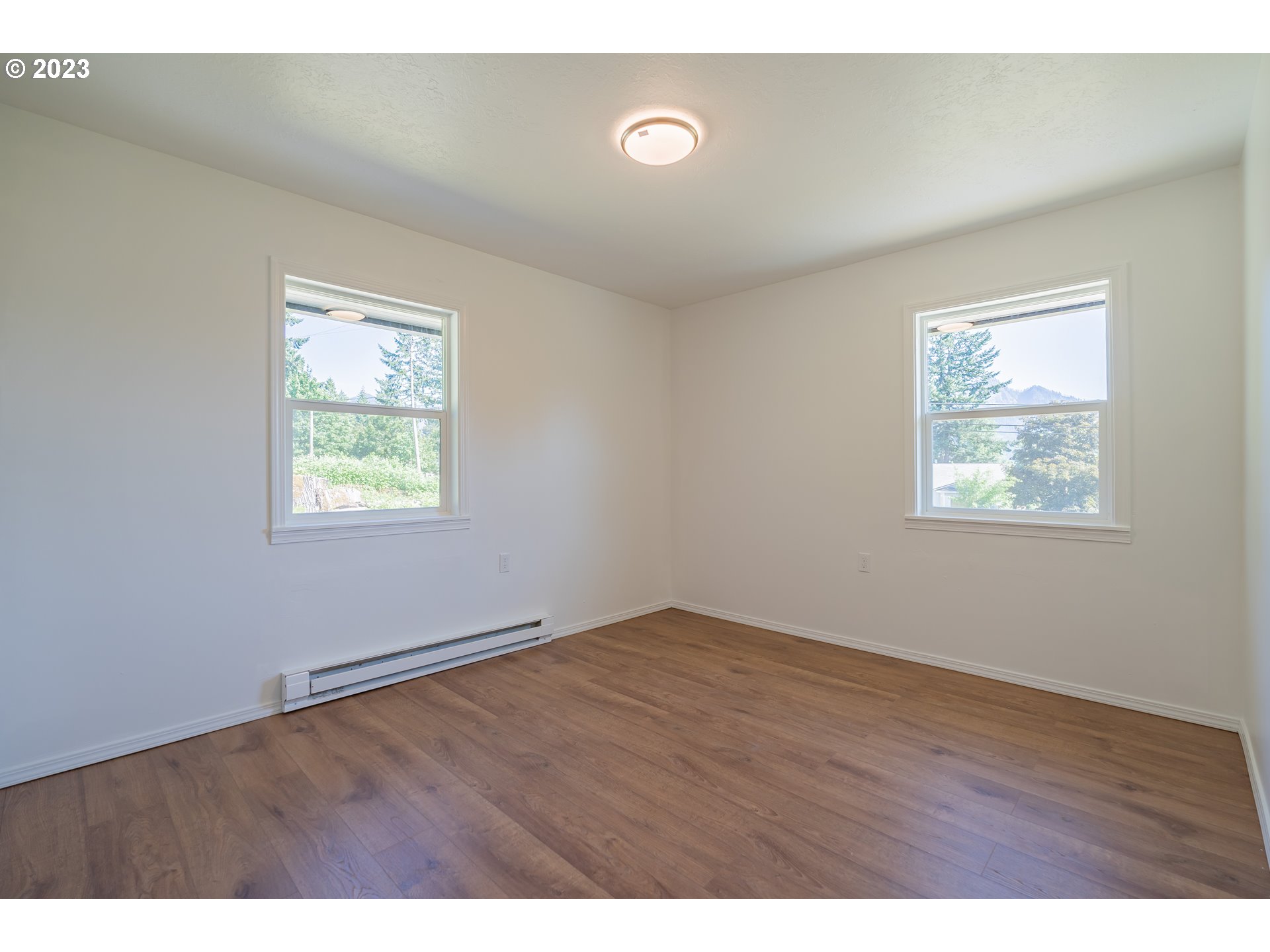 721 Northwest Gropper Road Stevenson, WA 98648 - Photo 36 of 45 an empty room with wooden floor and windows