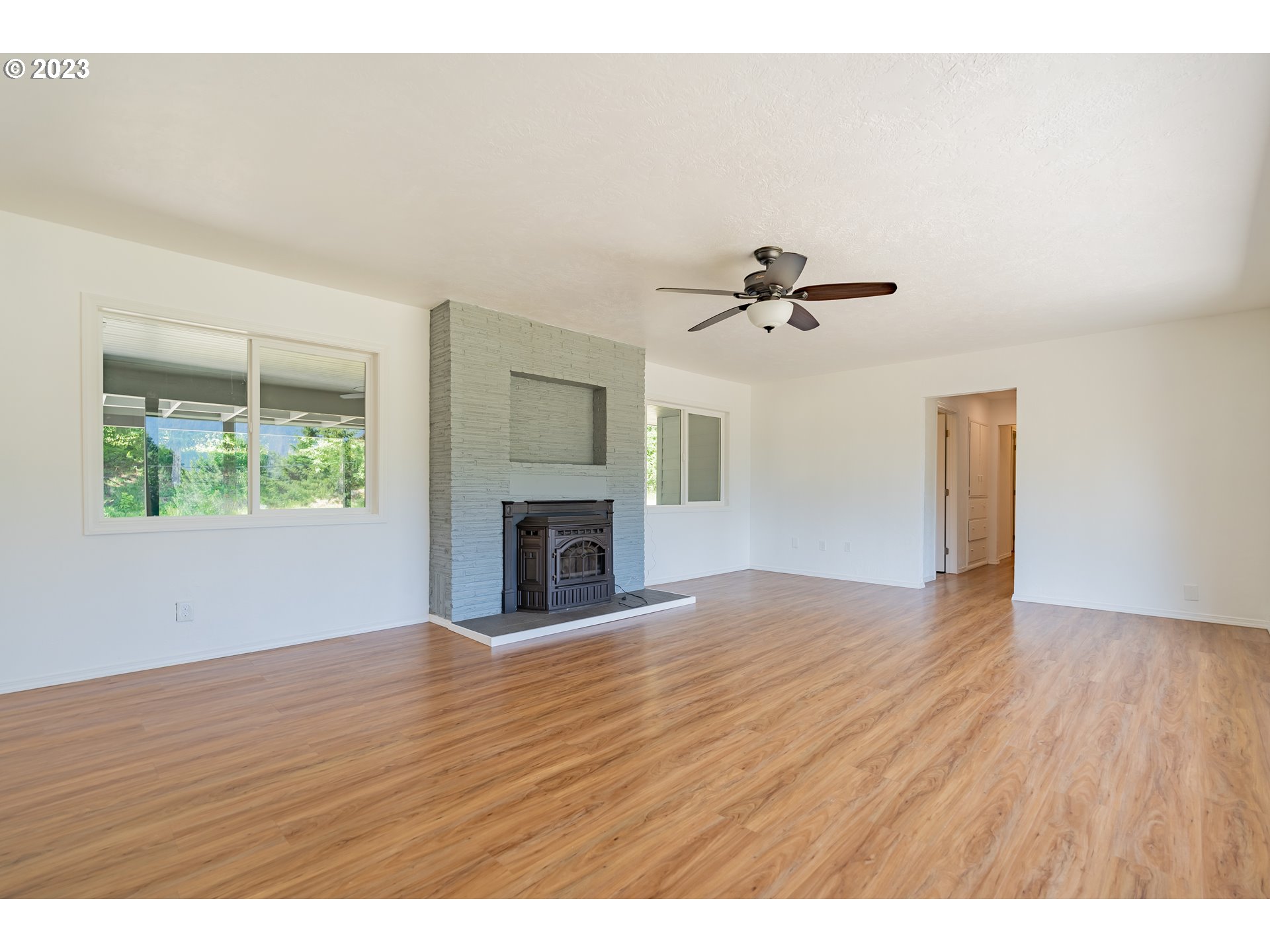 721 Northwest Gropper Road Stevenson, WA 98648 - Photo 6 of 45 a view of an empty room with wooden floor and a window