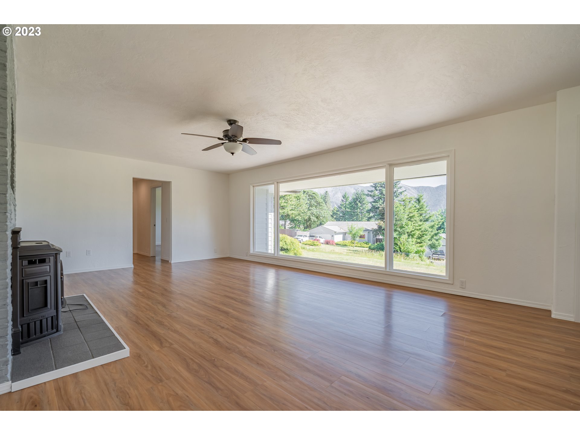 721 Northwest Gropper Road Stevenson, WA 98648 - Photo 7 of 45 a view of an empty room with wooden floor and a window