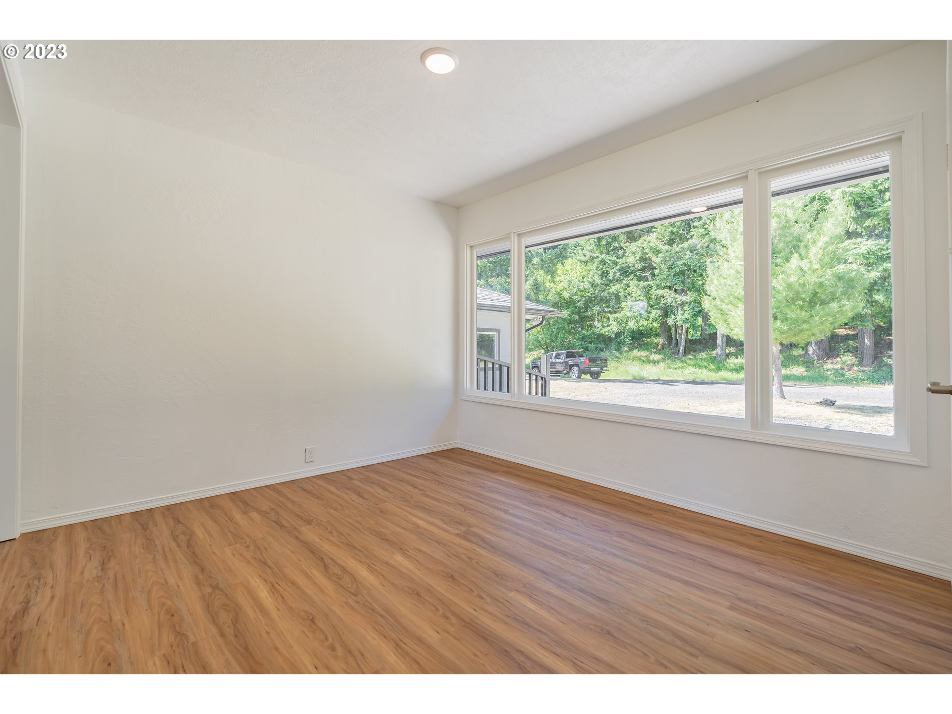 721 Northwest Gropper Road Stevenson, WA 98648 - Photo 10 of 45 a view of an empty room with wooden floor and a window
