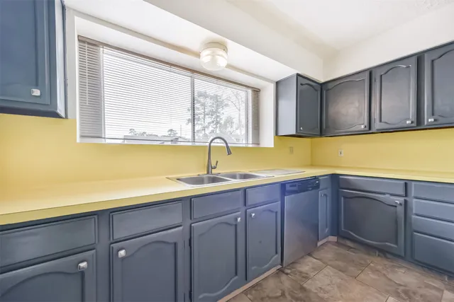 a kitchen with a sink and cabinets