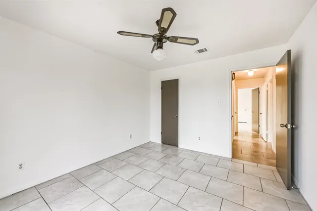a view of a livingroom with a ceiling fan and window