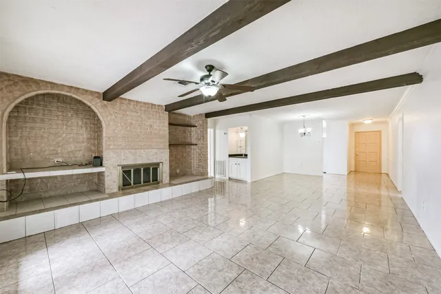 a view of an empty room with a fireplace