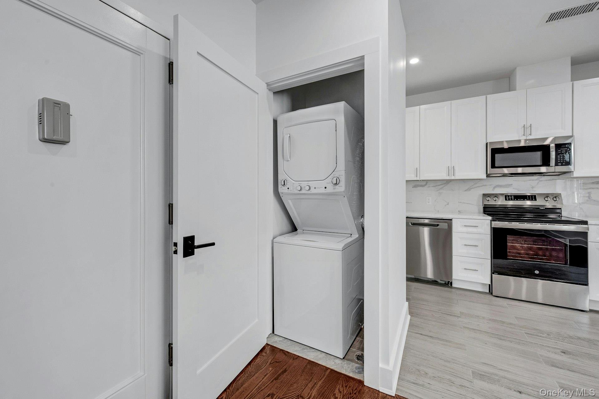 291 Main Street, Unit 1C Eastchester, NY 10709 - Photo 12 of 14 a kitchen with a refrigerator and a stove top oven