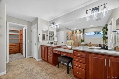 a hall with a sink and a refrigerator