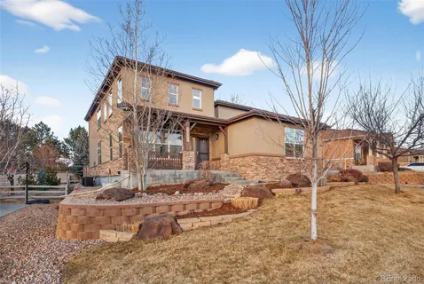 a view of a house with a yard covered in snow