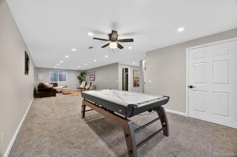 a living room with furniture a table and wooden floor