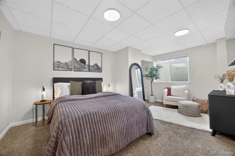 a bedroom with a bed and dresser with mirror