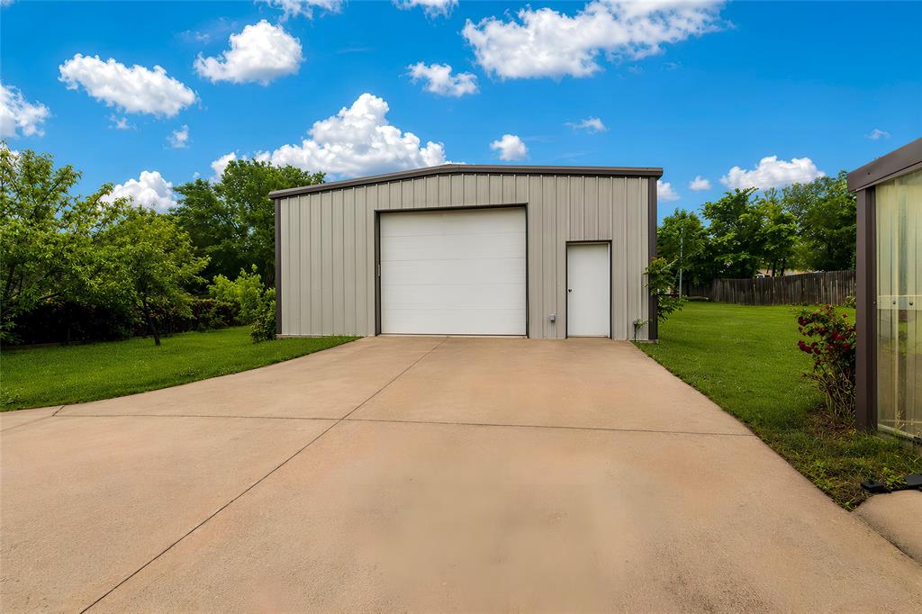 405 Kimbrough Road Azle, TX 76020 - Photo 30 of 39 a view of a house with a yard and garage
