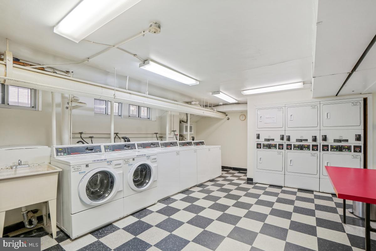 1954 Columbia Road Northwest, Unit 308 Washington, DC 20009 - Photo 26 of 51 a kitchen with a stove a sink and a refrigerator