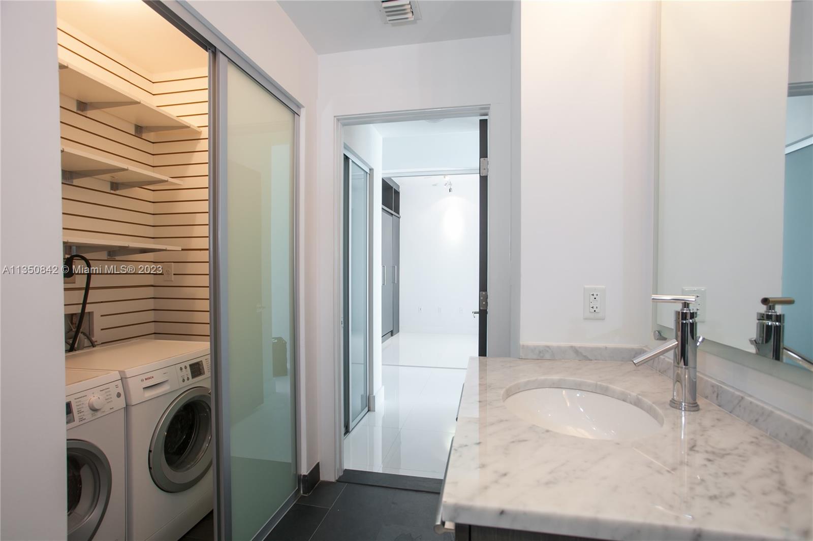 900 Biscayne Boulevard, Unit 4804 Miami, FL 33132 - Photo 11 of 17 a room with a washer and dryer