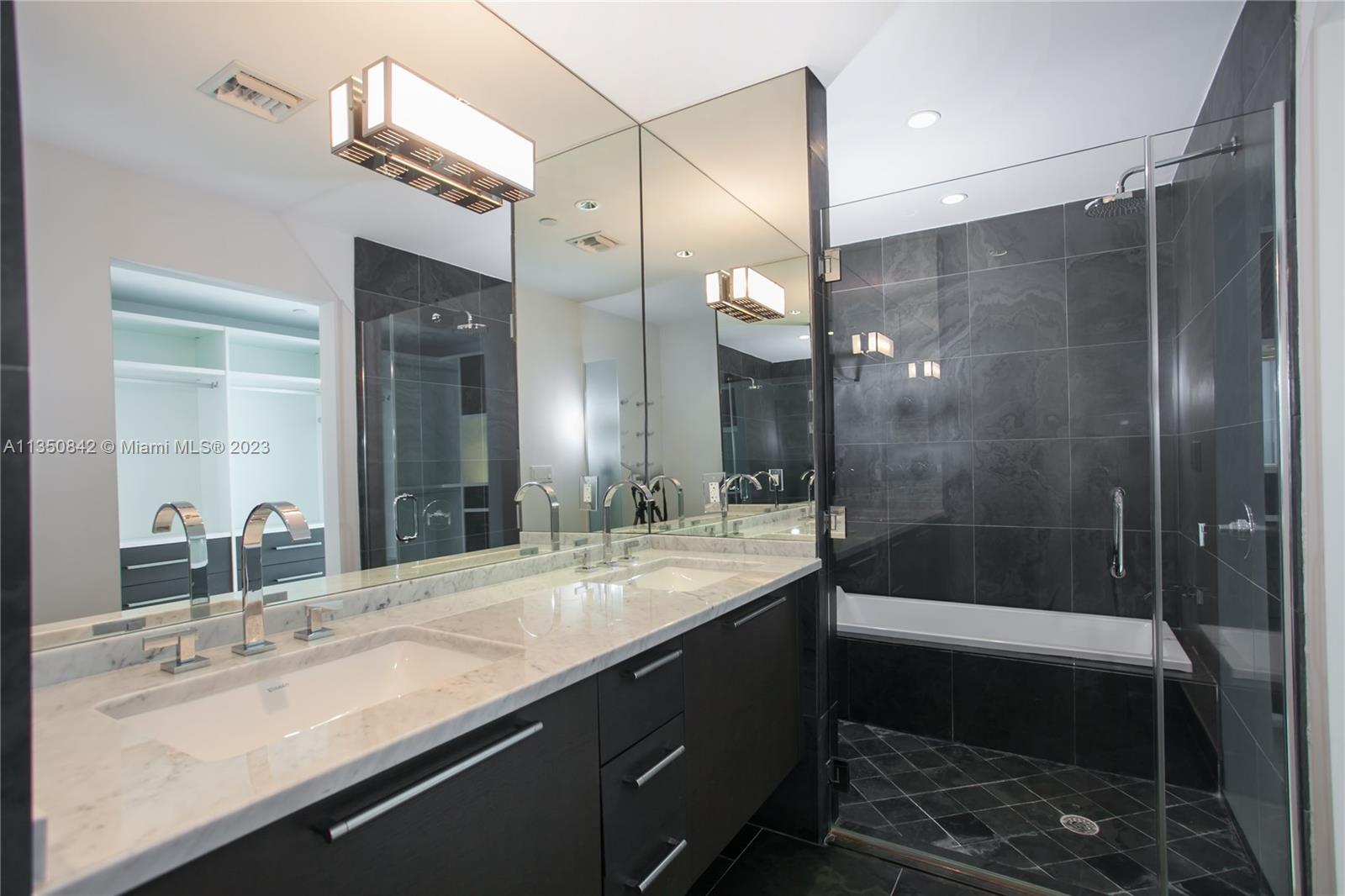 900 Biscayne Boulevard, Unit 4804 Miami, FL 33132 - Photo 13 of 17 a bathroom with a sink and a mirror
