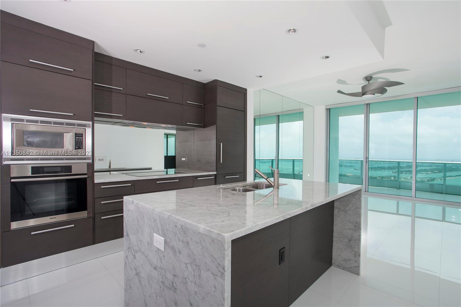 900 Biscayne Boulevard, Unit 4804 Miami, FL 33132 - Photo 2 of 17 a kitchen with a stove and a microwave