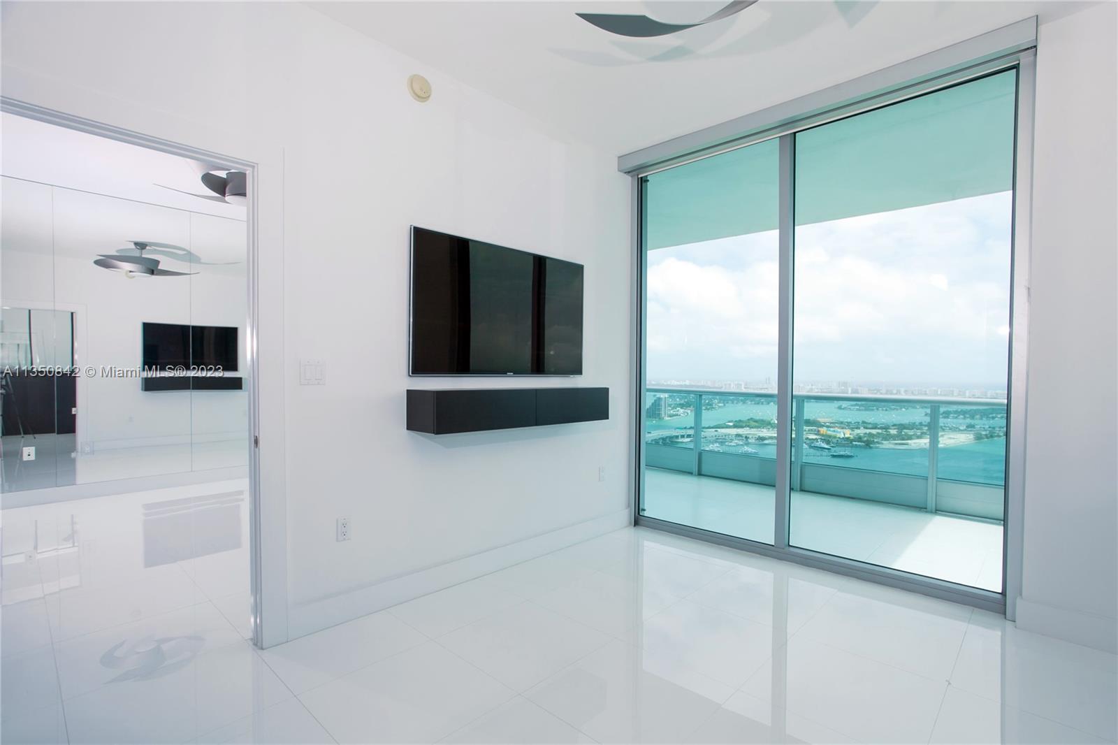 900 Biscayne Boulevard, Unit 4804 Miami, FL 33132 - Photo 4 of 17 a view of a livingroom with an empty space and a flat screen tv