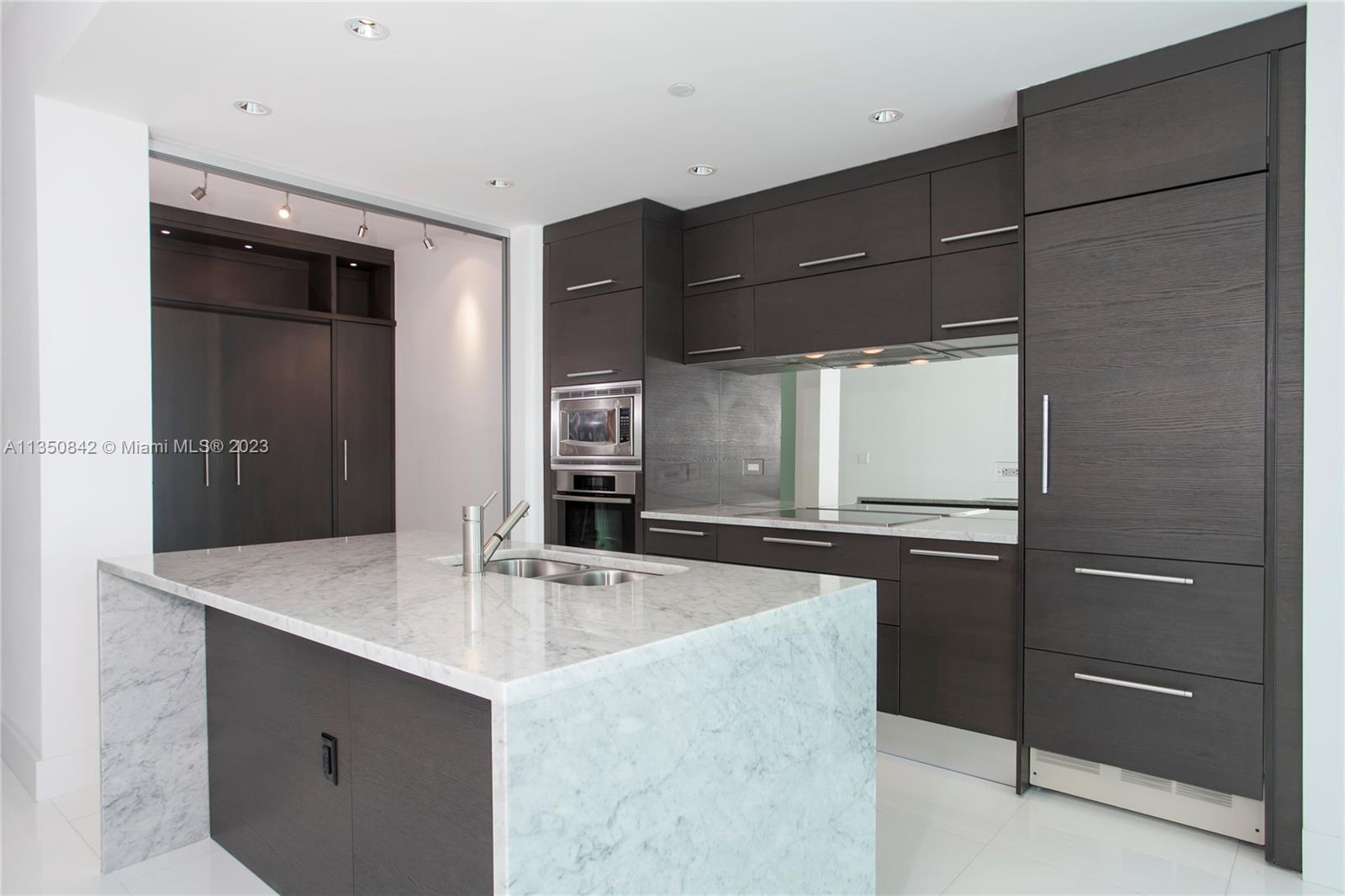 900 Biscayne Boulevard, Unit 4804 Miami, FL 33132 - Photo 6 of 17 a kitchen with a sink and cabinets