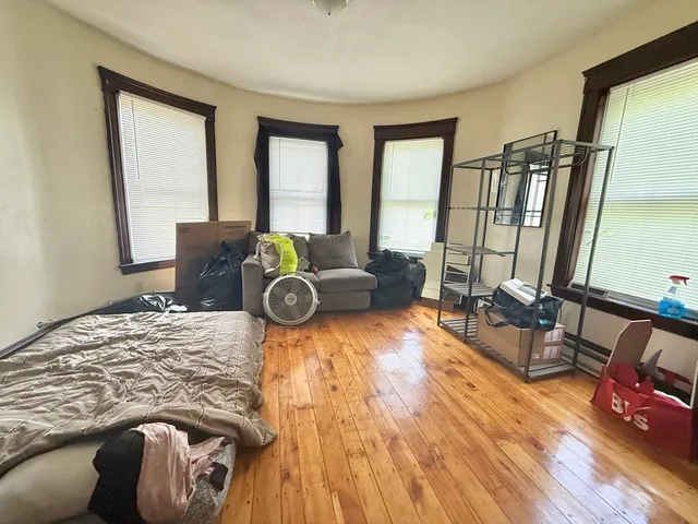 a bedroom with furniture and a large window