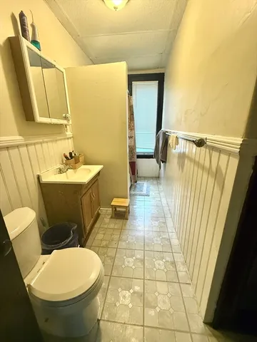 a bathroom with a sink a toilet and a mirror