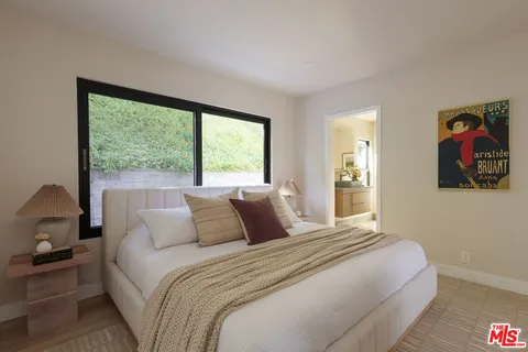 a bedroom with a large bed and a window