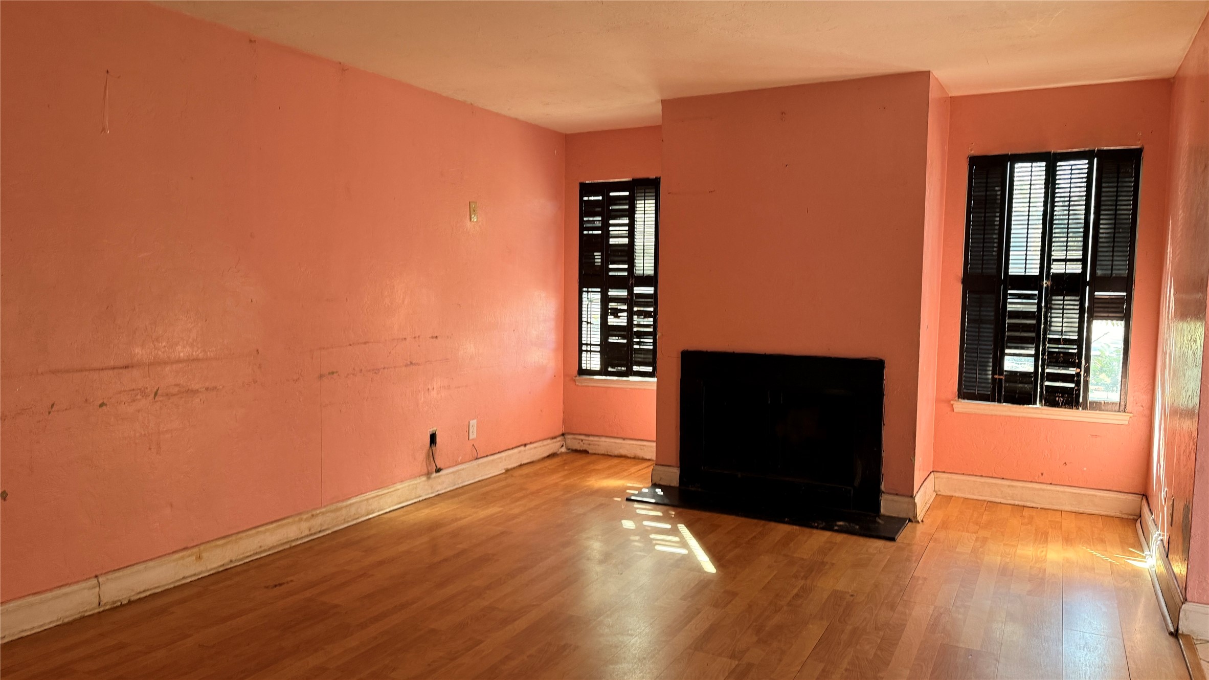 9010 Imogene Street, Unit A Houston, TX 77036 - Photo 2 of 8 an empty room with wooden floor and cabinet