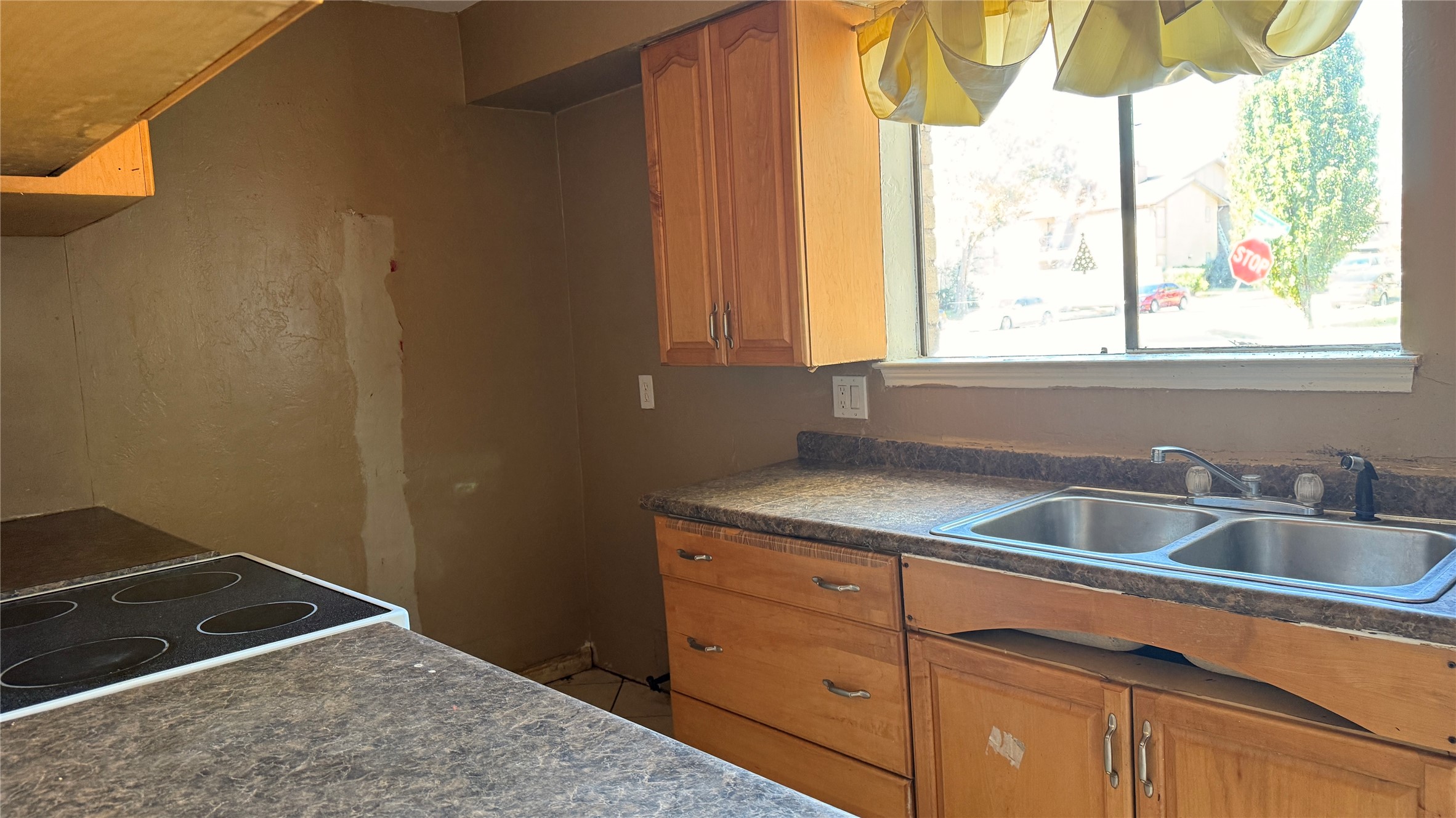 9010 Imogene Street, Unit A Houston, TX 77036 - Photo 3 of 8 a kitchen with a sink and a window