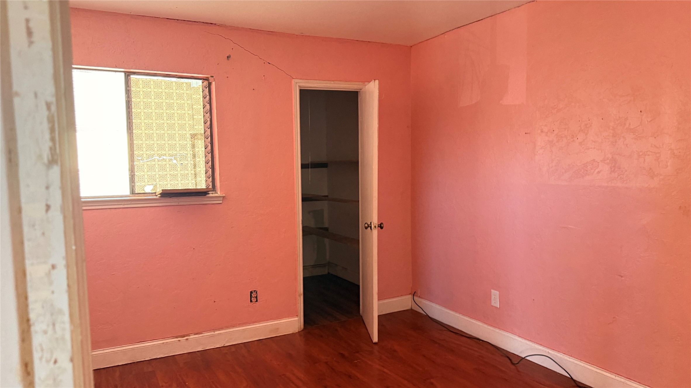 9010 Imogene Street, Unit A Houston, TX 77036 - Photo 5 of 8 an empty room with wooden floor and windows