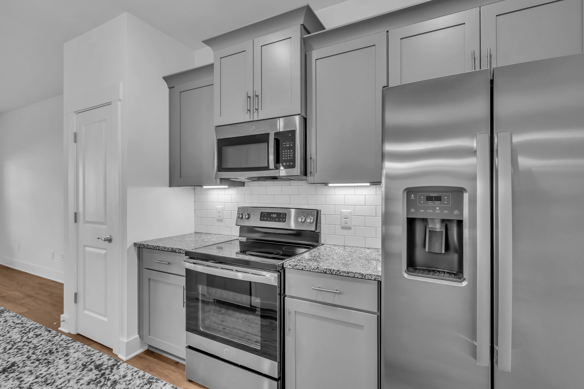 7144 Gracious Drive Franklin, TN 37064 - Photo 10 of 28 a kitchen with refrigerator a microwave a stove and cabinets