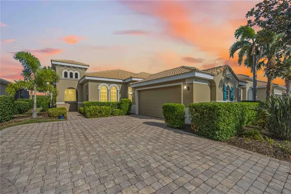 a front view of a house with a yard and a garage