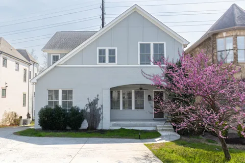 a front view of a house with a garden and plants