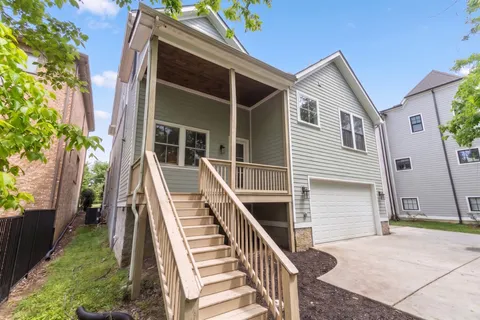 a front view of house with deck and yard