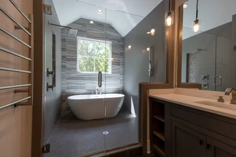a bathroom with a tub sink and mirror