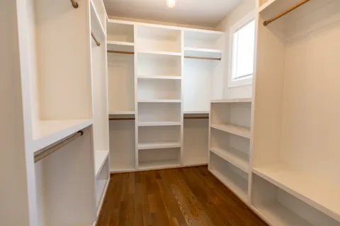 a view of walk in closet with empty racks