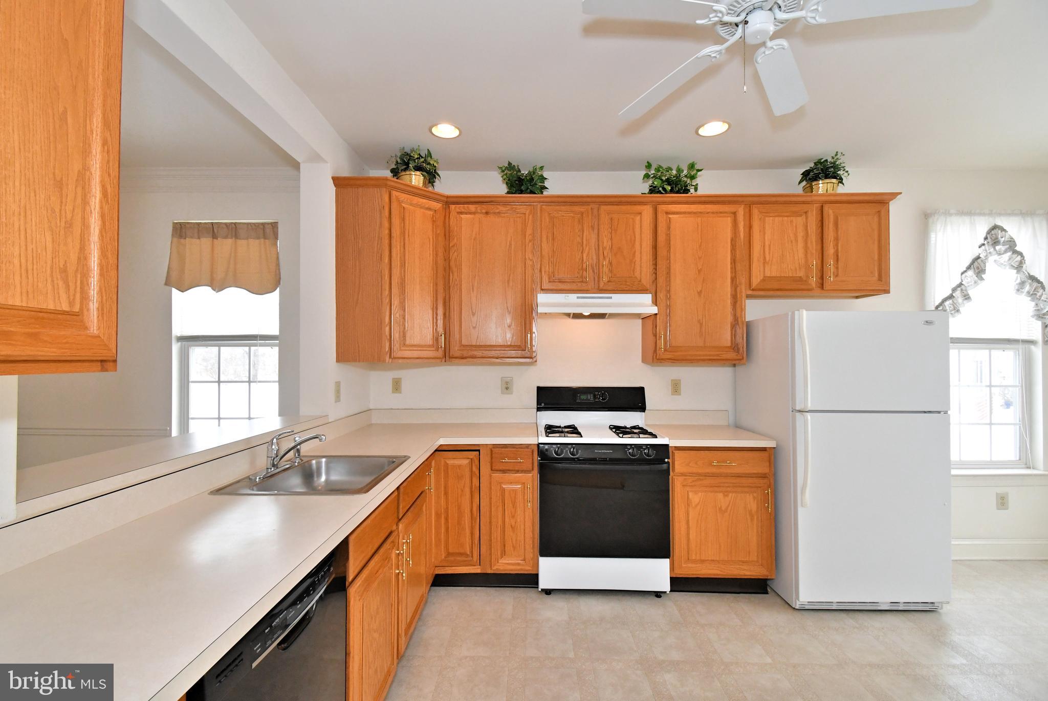 425 Ruth Court Harleysville, PA 19438 - Photo 11 of 26 a kitchen with a stove a sink and a refrigerator