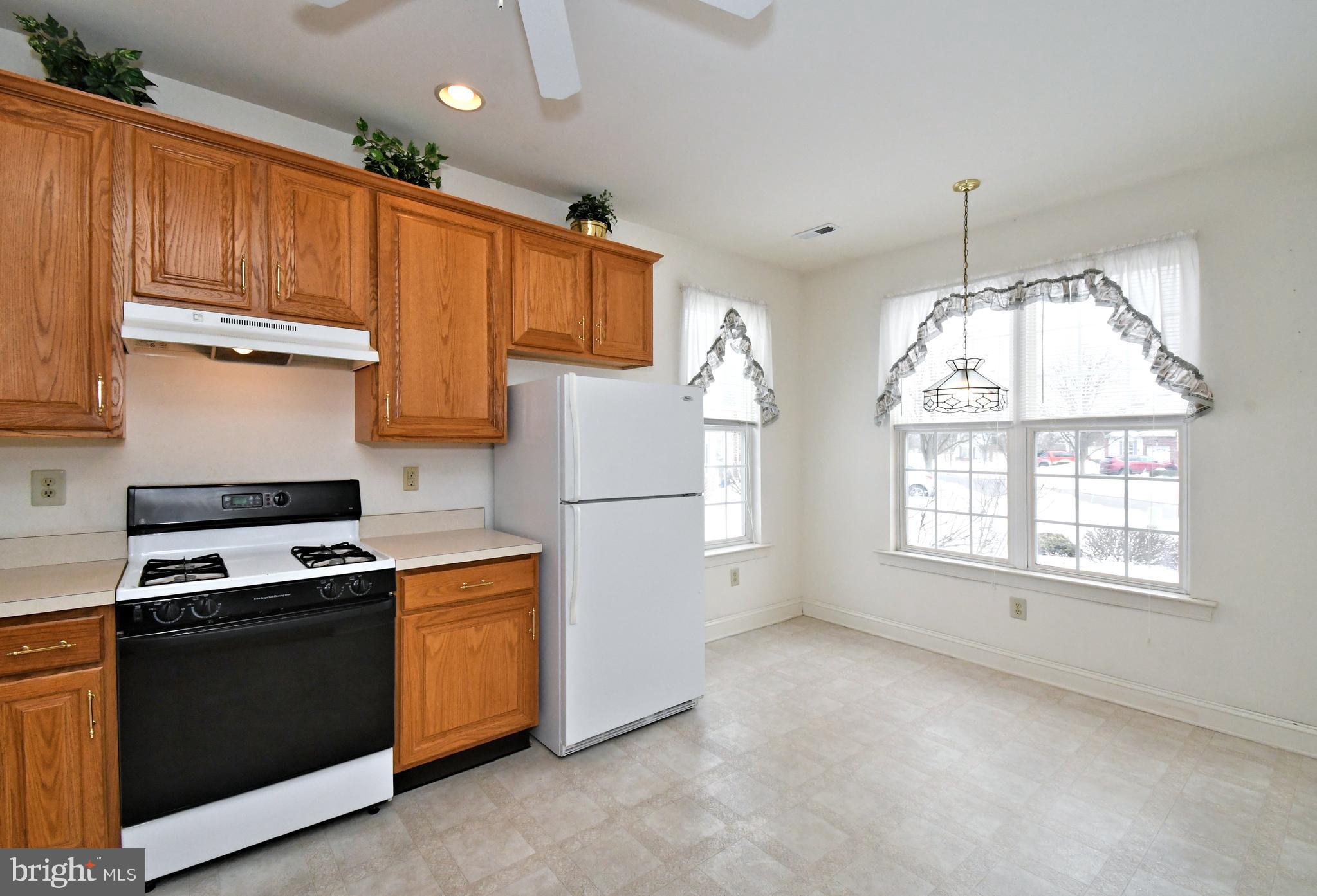 425 Ruth Court Harleysville, PA 19438 - Photo 12 of 26 a kitchen with stainless steel appliances granite countertop a stove a refrigerator and a sink with wooden cabinets