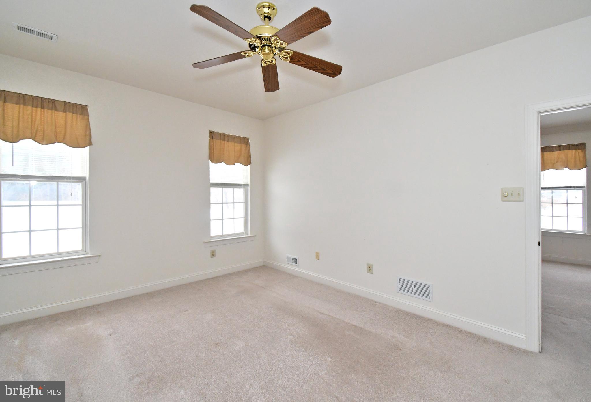 425 Ruth Court Harleysville, PA 19438 - Photo 14 of 26 an empty room with windows and fan