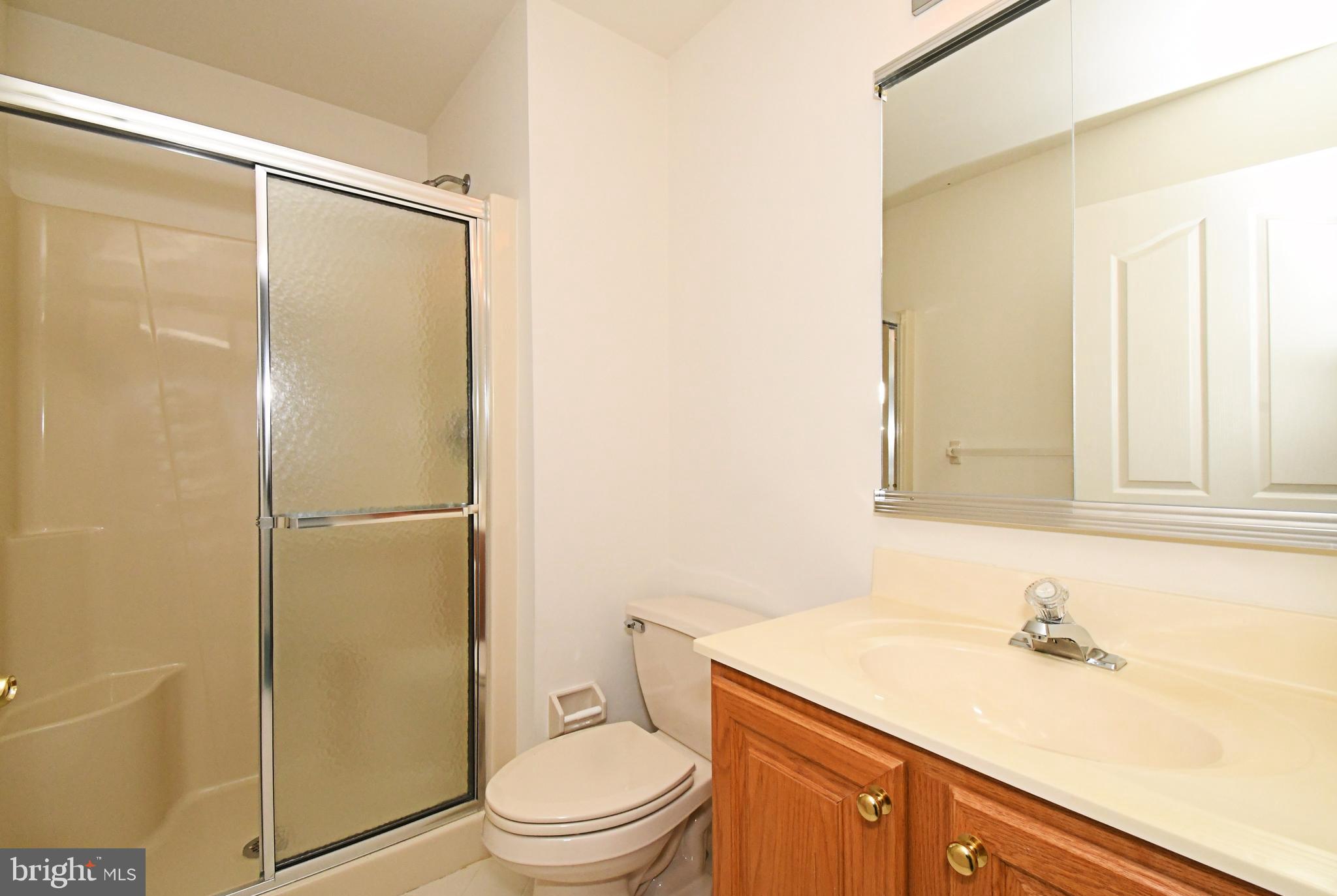 425 Ruth Court Harleysville, PA 19438 - Photo 23 of 26 a bathroom with a granite countertop sink toilet and shower